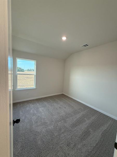 3rd bedroom (upstairs) with carpet, vaulted ceiling, and recessed lighting 3rd bedroom (upstairs) with carpet, vaulted ceiling, and recessed lighting