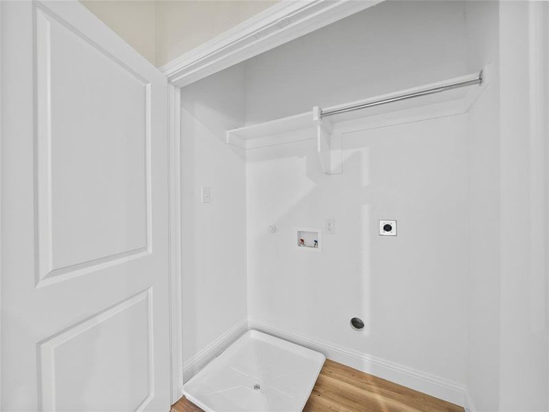 Laundry area featuring hookup for a washing machine, hookup for a gas dryer, hookup for an electric dryer, wood finished floors, and laundry area