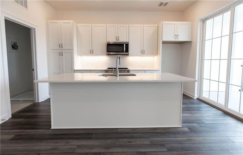 Huge 8 ft solid quartz countertops with GE Appliances *Home is Under Construction. Photos shown are from other TPG Communities to display how the home will live*