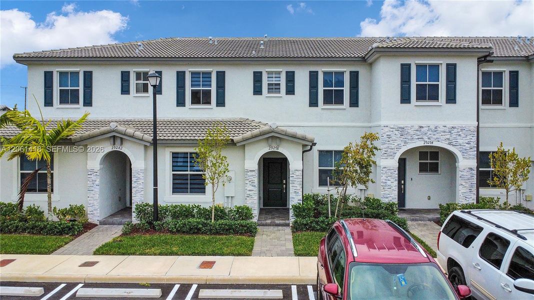 Front exterior of a new home in , Homestead, FL, highlighting curb appeal (Image 1). Front exterior of a new home in , Homestead, FL, highlighting curb appeal (Image 1).