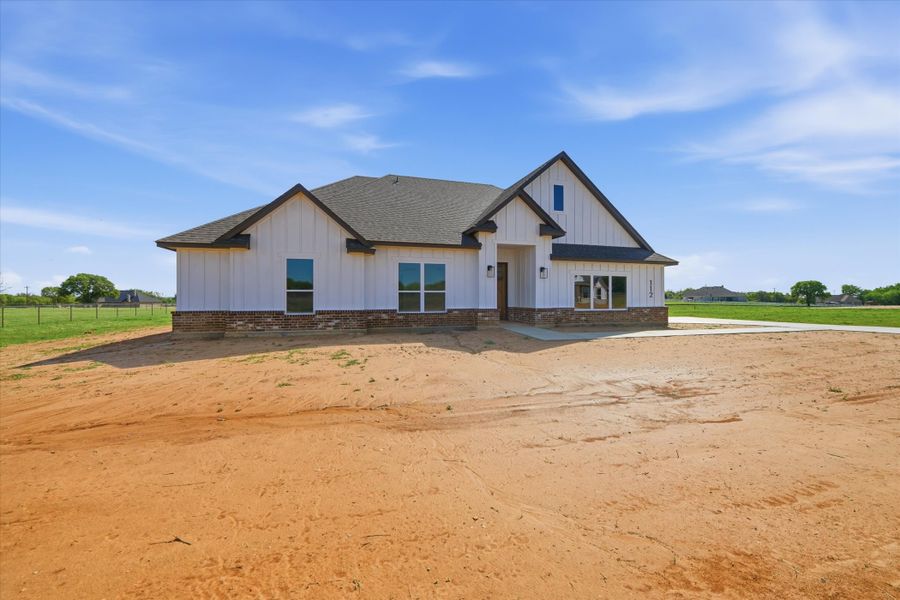 Front exterior of a new home in Zion Valley, Poolville, TX, highlighting curb appeal (Image 1). Front exterior of a new home in Zion Valley, Poolville, TX, highlighting curb appeal (Image 1).