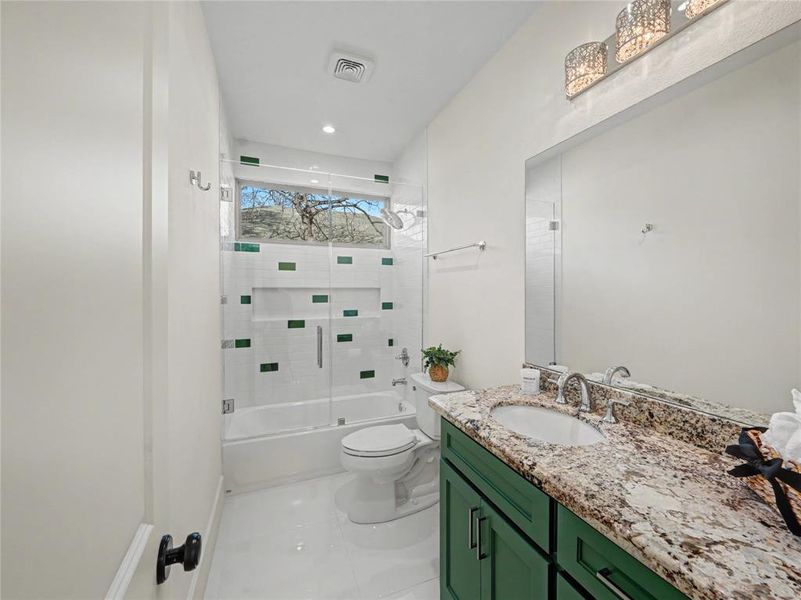 Bathroom with vanity, combined bath / shower with glass door, recessed lighting, and light tile patterned flooring