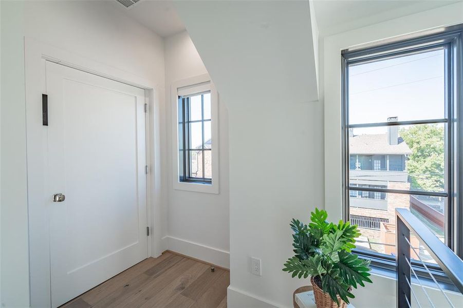 Private elevator/3rd floor landing featuring light wood flooring and a healthy amount of sunlight