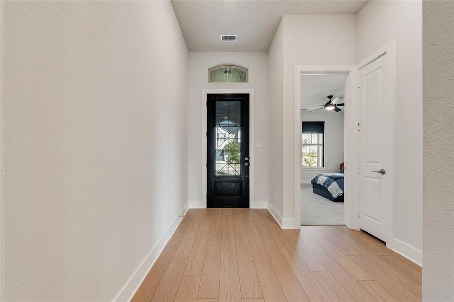 Foyer entrance featuring light wood-style flooring and a ceiling fan