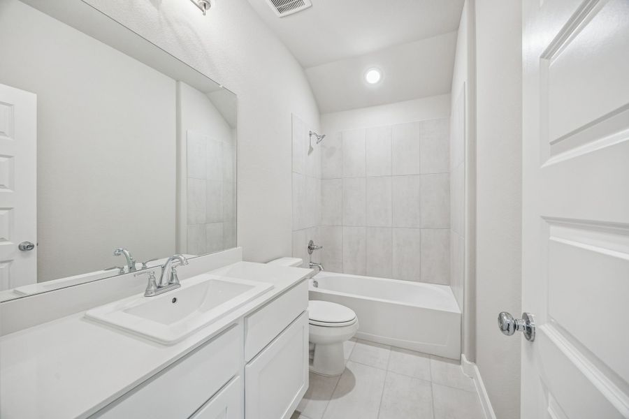 Bathroom in the Heisman home plan by Trophy Signature Homes – REPRESENTATIVE PHOTO