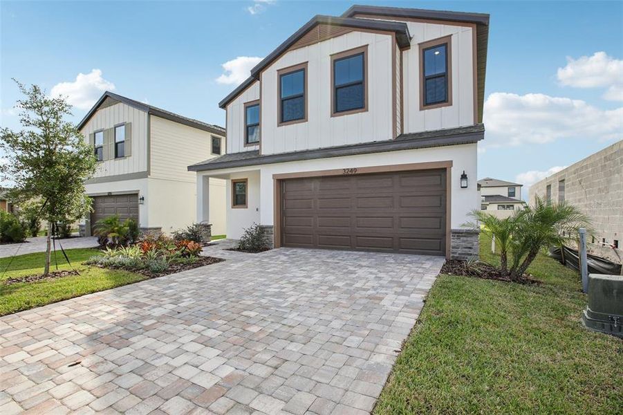 Front exterior of a new home in Grasslands West, Lakeland, FL, highlighting curb appeal (Image 2).