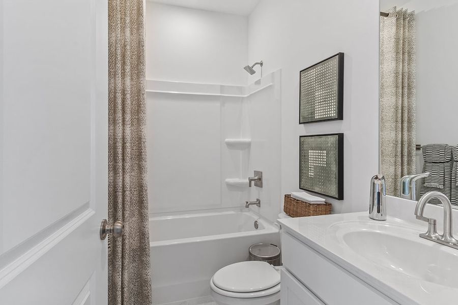 A bathroom with a tub sink and toilet.