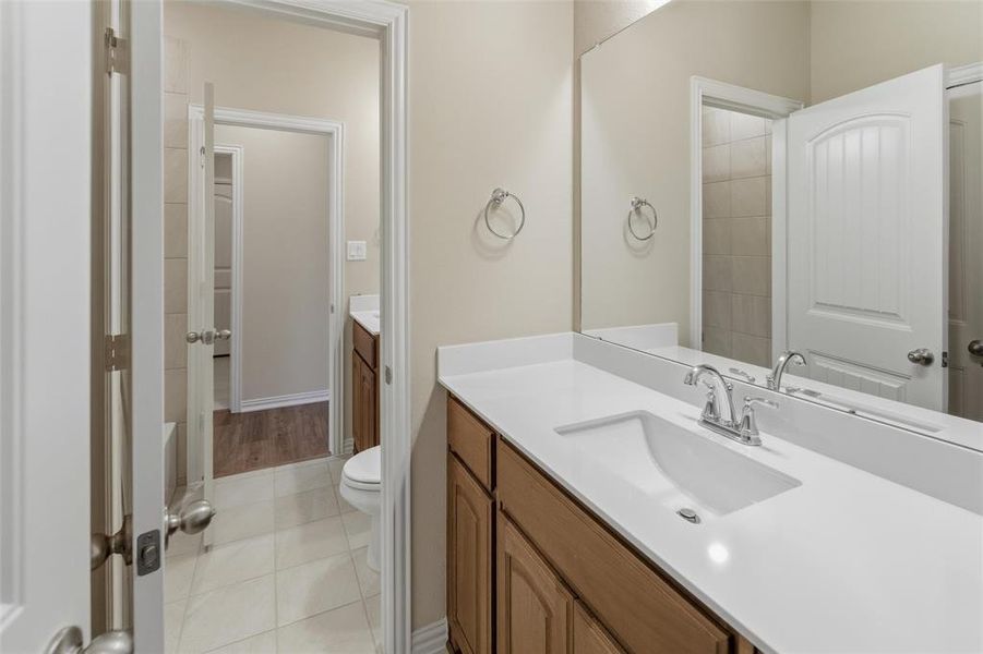 Bathroom with vanity and light tile patterned floors