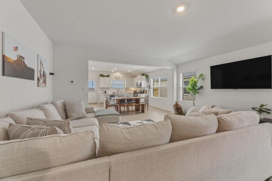 The property features an open-concept living area with light-colored walls and recessed lighting