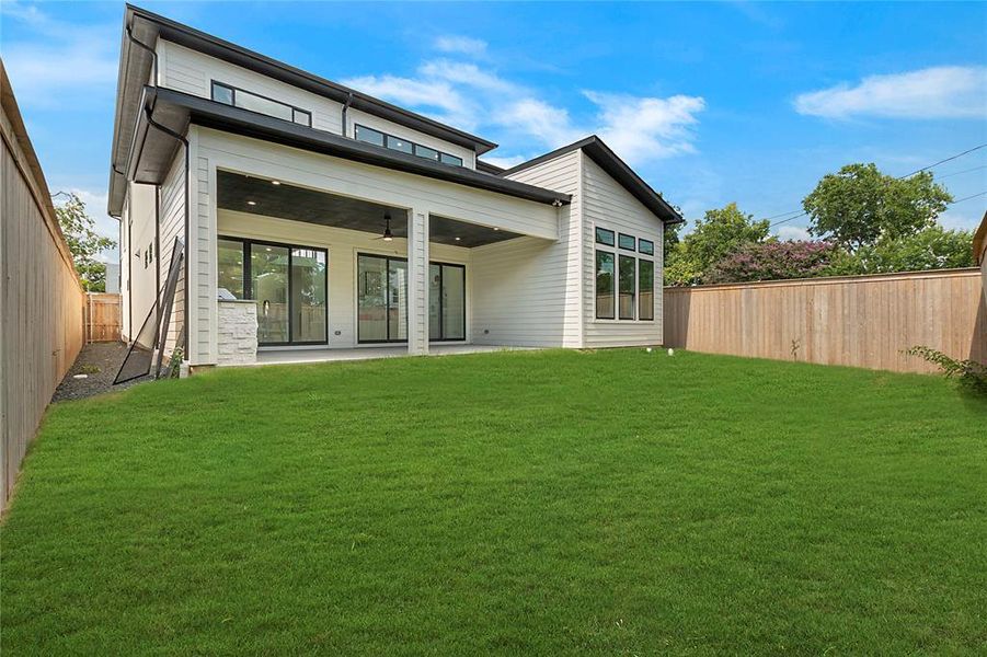 Rear view of house with a patio, a lawn, and ceiling fan