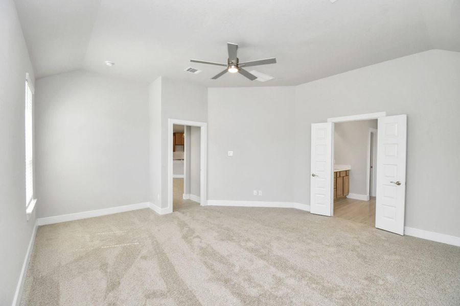 Escape to tranquility in this spacious primary room, adorned with plush carpeting and bathed in the soothing hues of warm paint colors, creating a cozy retreat for relaxation. Escape to tranquility in this spacious primary room, adorned with plush carpeting and bathed in the soothing hues of warm paint colors, creating a cozy retreat for relaxation.