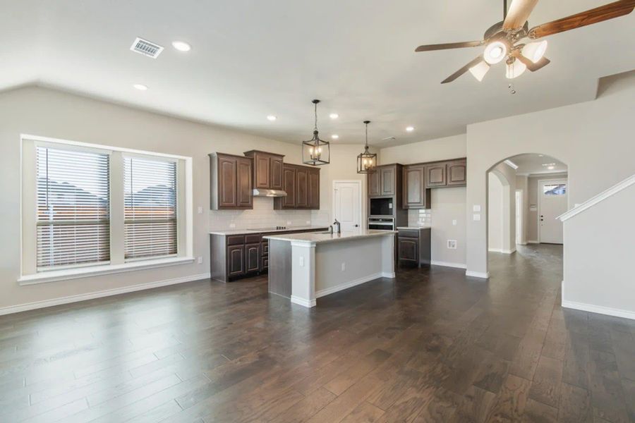 Family Room & Kitchen | Concept 2440 at Hulen Trails in Fort Worth, TX by Landsea Homes