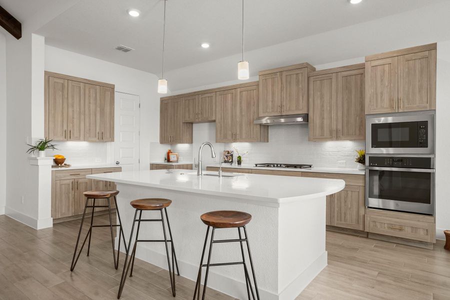 Modern kitchen with sleek cabinetry and a large central island for casual dining.