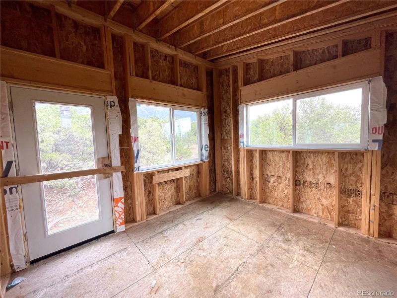 Upstairs bedroom with door to future balcony