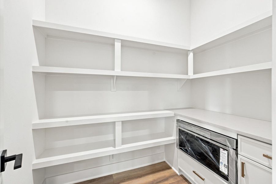Walk-in pantry has a microwave and ample storage. Walk-in pantry has a microwave and ample storage.