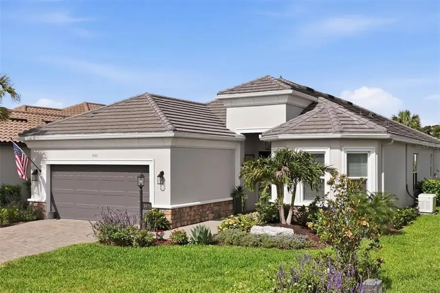 Front exterior of a new home in Esplanade at Azario Lakewood Ranch, Bradenton, FL, highlighting curb appeal (Image 20).
