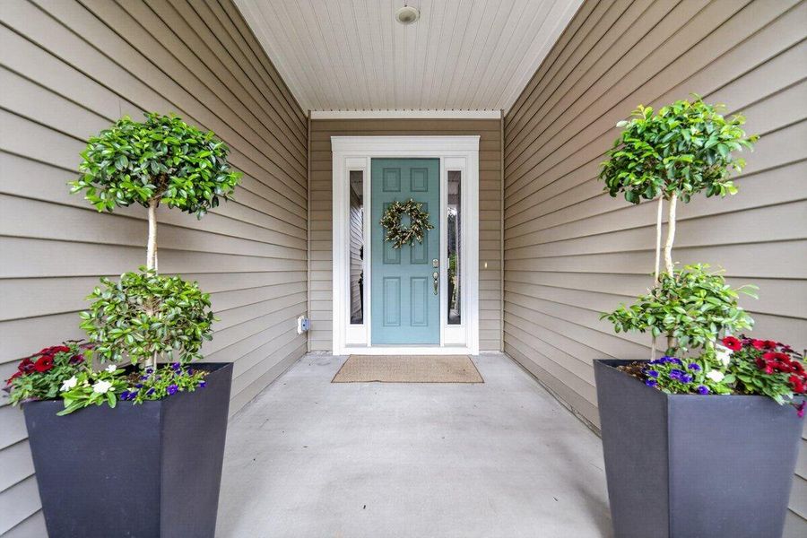 Exterior details and patio area of a home in K. Hovnanian's® Four Seasons at Lakes of Cane Bay, Summerville (Image 28).