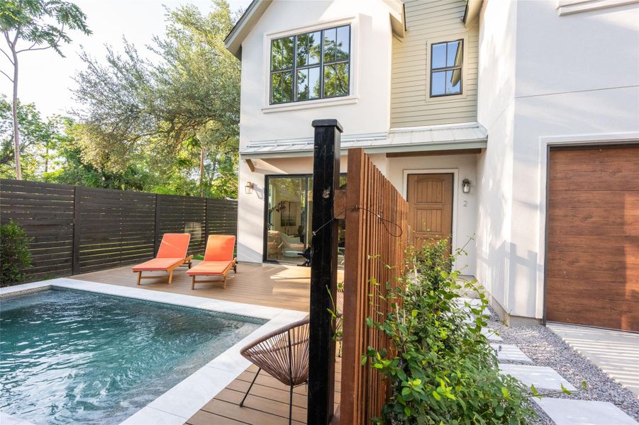 A private pool with a spacious deck offers a tranquil outdoor escape, complemented by modern architecture.