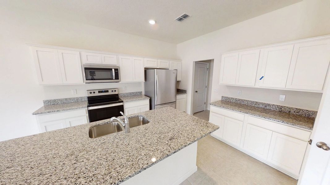 Representative furnished interior of a home built from the Discovery by Starlight Homes in Pelham Square, Deland (Image 5).