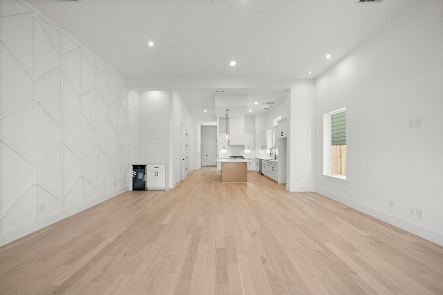 Alternate view of living/dining room with 12' ceilings, light & bright throughout. (Photo is of a previously completed home.)