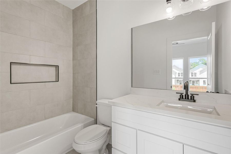 Well-appointed third bathroom showcasing a tub-shower combo, perfect for relaxing baths or quick showers. This stylish and practical space provides comfort and convenience for family and guests alike, making every day feel a little more special.