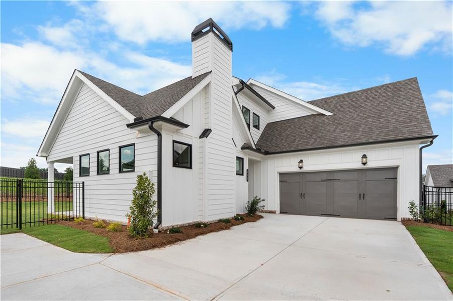 Front exterior of a new home in Promenade at Sawnee Village, Cumming, GA, highlighting curb appeal (Image 26).