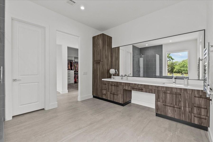 The 15 x 12 primary ensuite is a true spa-inspired sanctuary, with black teak finish cabinets and soft close drawers.