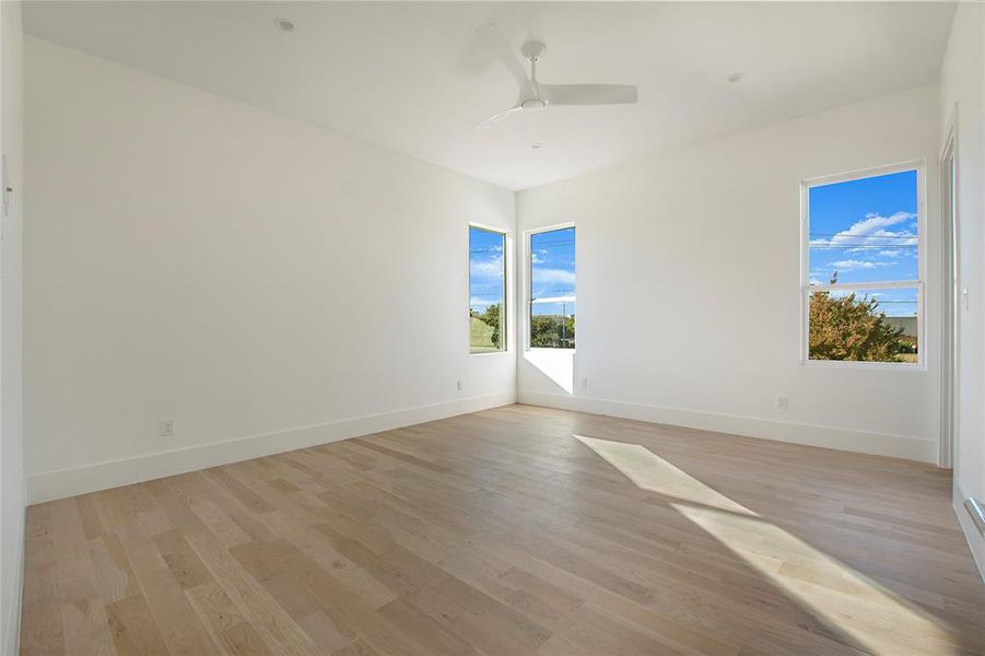 Spare room with ceiling fan and light wood-type flooring