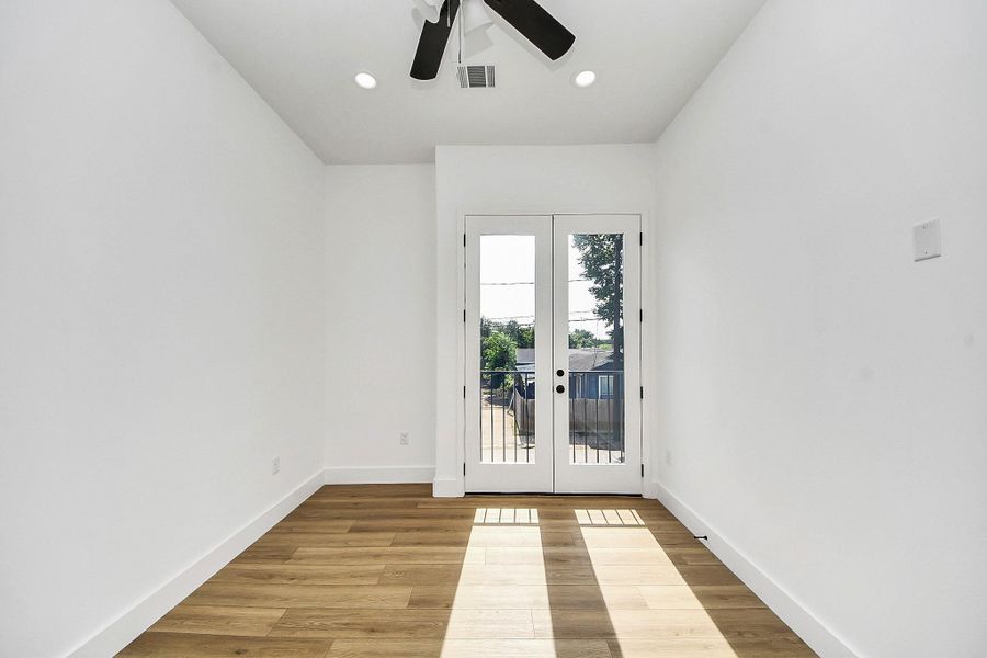 Bright and inviting guest bedroom featuring modern finishes, abundant natural light, and a clean, neutral design. A comfortable and versatile space perfect for hosting guests or creating a cozy retreat.