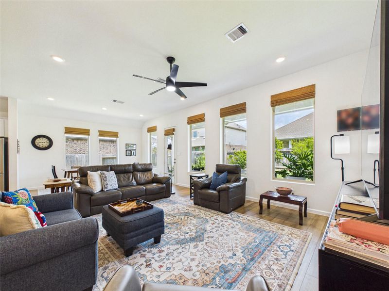 Another view of the 19x16 living room and adjoining dining room flooded with natural light from all of the windows overlooking the backyard.
