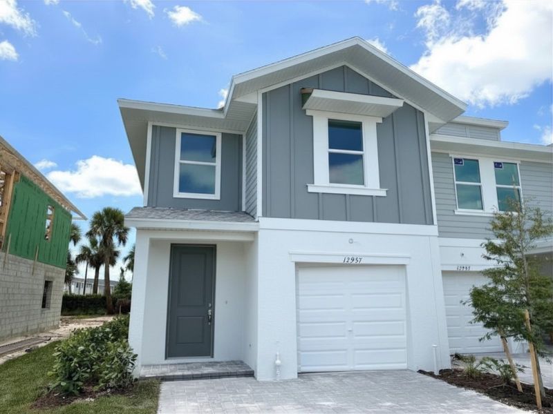 Front exterior of a new home in Meritage Homes at Central Park, Port St. Lucie, FL, highlighting curb appeal (Image 2). Front exterior of a new home in Meritage Homes at Central Park, Port St. Lucie, FL, highlighting curb appeal (Image 2).