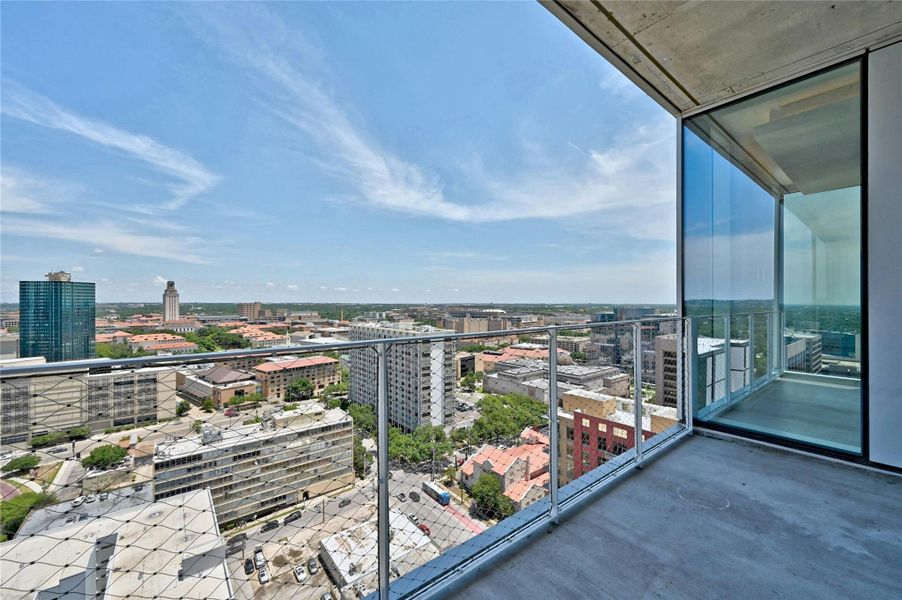 Private balcony with sweeping skyline vistas and plenty of space for outdoor dining or lounging.