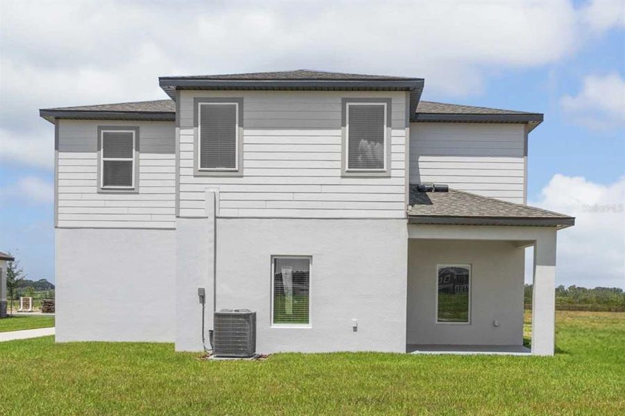 Front exterior of a new home in Gum Lake Preserve, Lake Alfred, FL, highlighting curb appeal (Image 17).