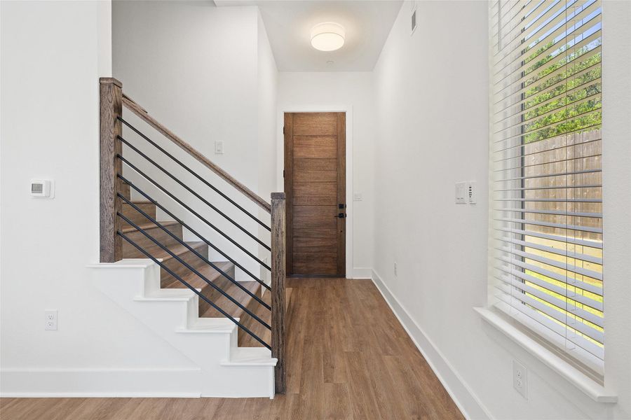 Entryway featuring wood finished floors and baseboards Entryway featuring wood finished floors and baseboards