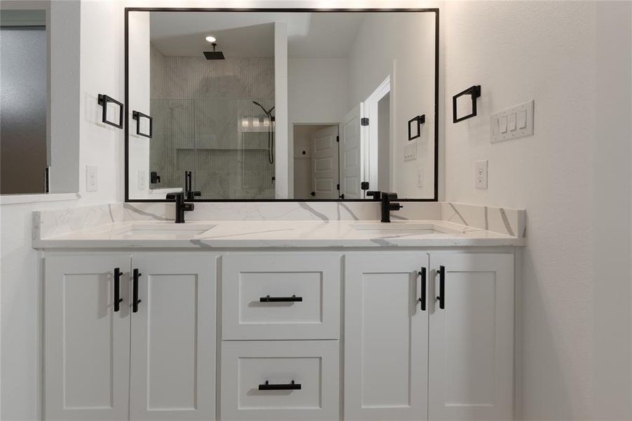 Full bathroom with a stall shower and double vanity