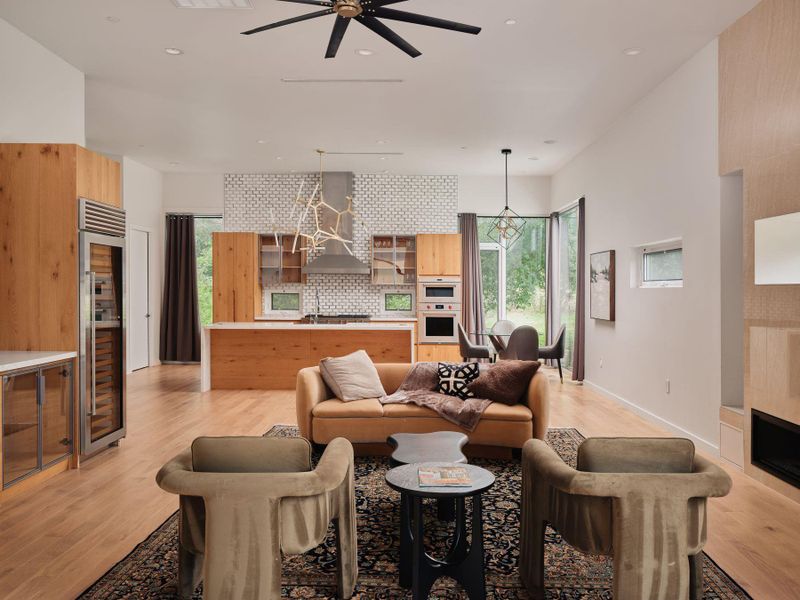 An open concept living area seamlessly blends kitchen and living spaces with warm wood tones and modern fixtures. An open concept living area seamlessly blends kitchen and living spaces with warm wood tones and modern fixtures.