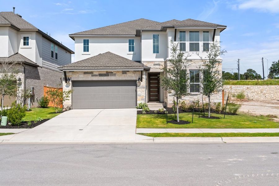 Front exterior of a new home in Park Collection at Lariat, Liberty Hill, TX, highlighting curb appeal (Image 1). Front exterior of a new home in Park Collection at Lariat, Liberty Hill, TX, highlighting curb appeal (Image 1).