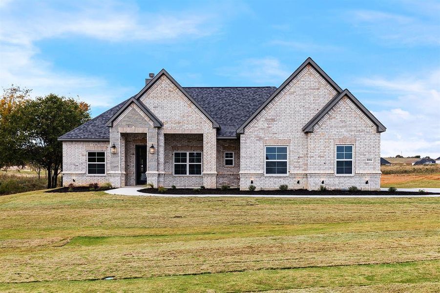 View of front of home featuring a front lawn