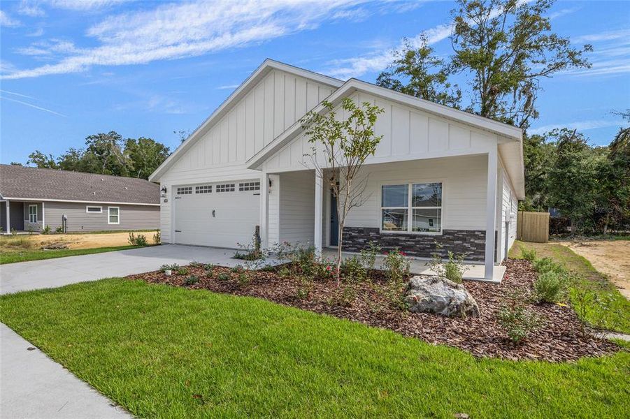Front exterior of a new home in Grand Oaks, Gainesville, FL, highlighting curb appeal (Image 19).