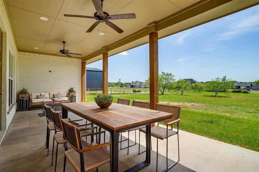 View of patio / terrace with a ceiling fan, outdoor dining space, and an outdoor living space