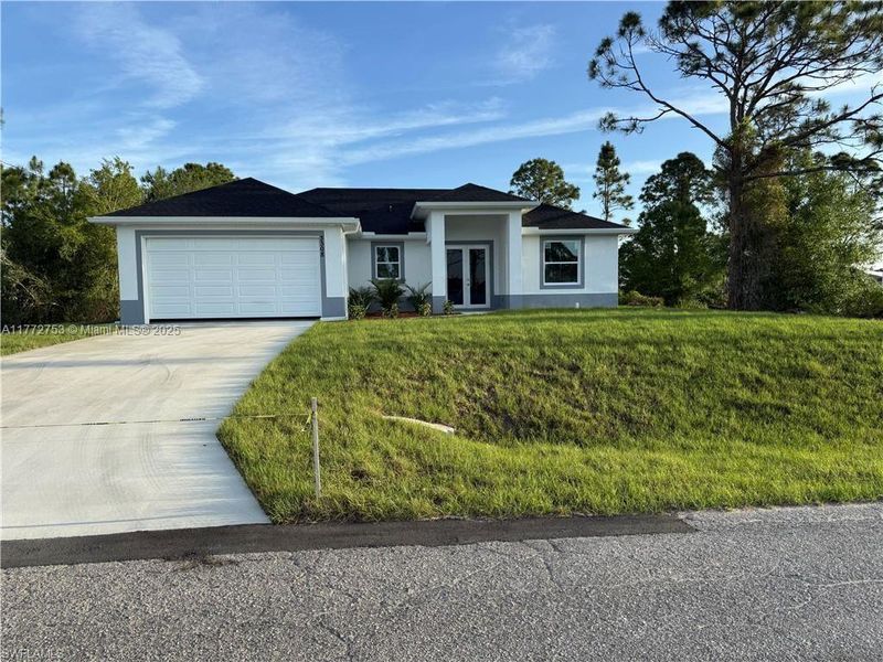 Front exterior of a new home in , Lehigh Acres, FL, highlighting curb appeal (Image 23).