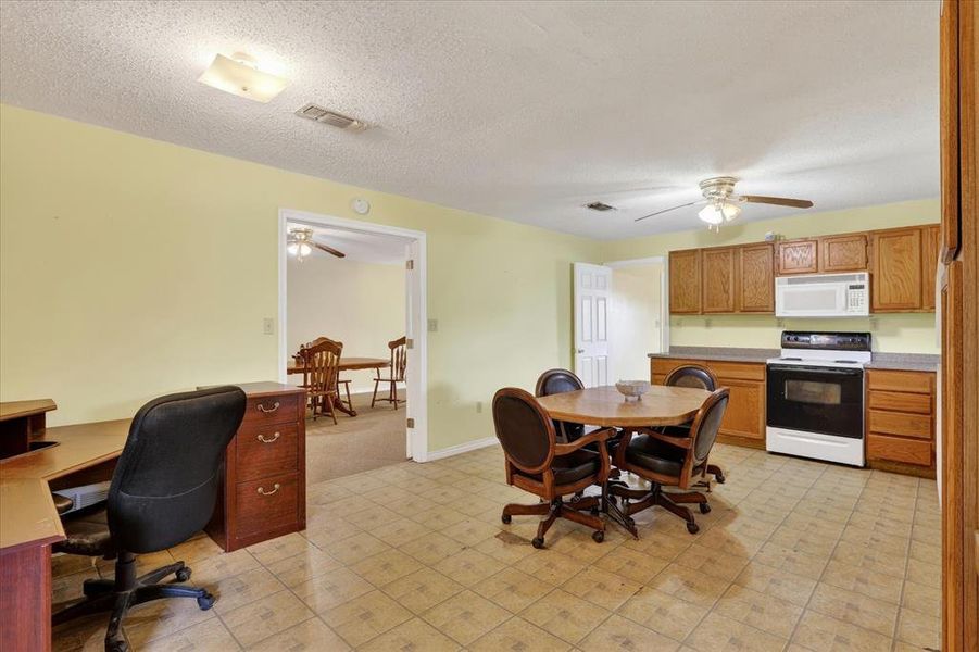 Kitchen with range, microwave and ceiling fan