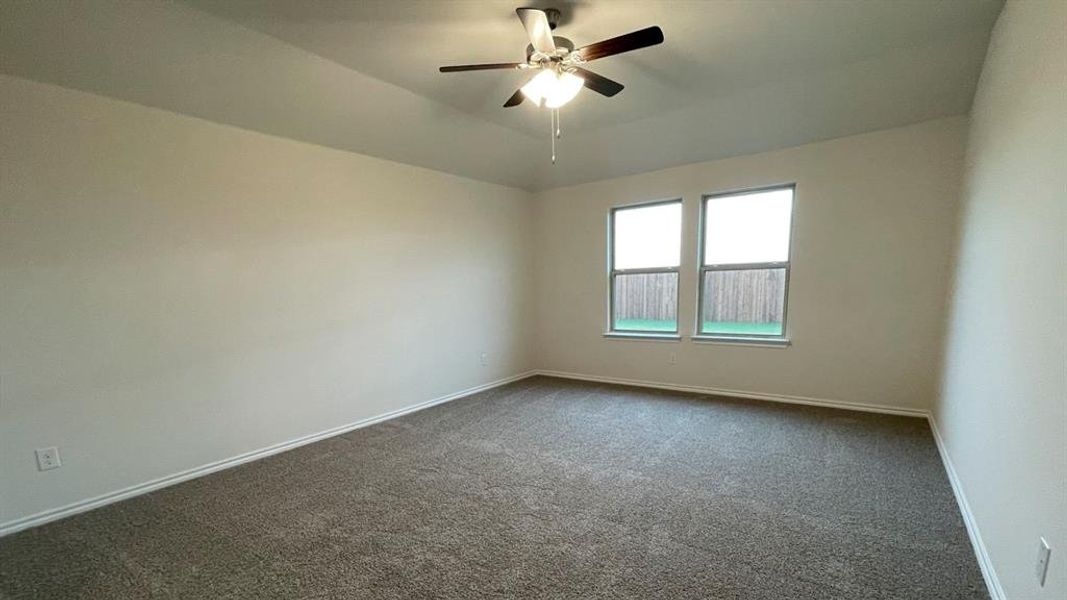 Spacious room featuring neutral carpeting and light-toned walls Spacious room featuring neutral carpeting and light-toned walls