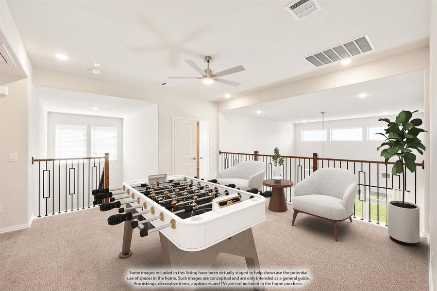 Upstairs game room with foosball table, seating area, ceiling fan, and open railing overlooking lower floor Upstairs game room with foosball table, seating area, ceiling fan, and open railing overlooking lower floor