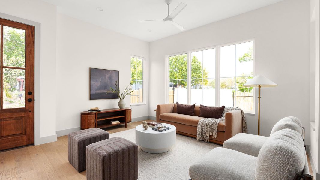 Living area with a ceiling fan and wood finished floors