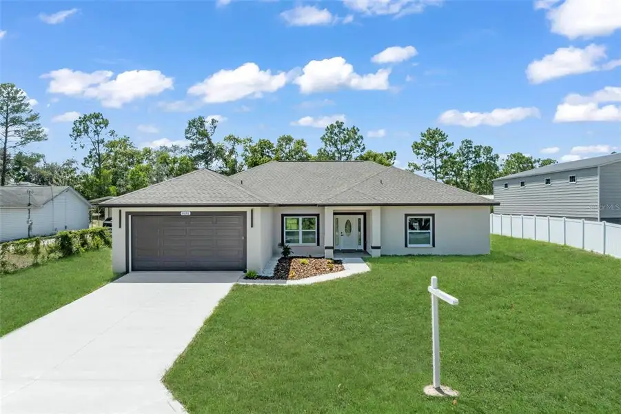 Front exterior of a new home in , Weeki Wachee, FL, highlighting curb appeal (Image 19).