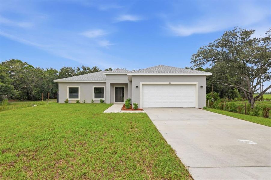 Front exterior of a new home in , Yeehaw Junction, FL, highlighting curb appeal (Image 26).