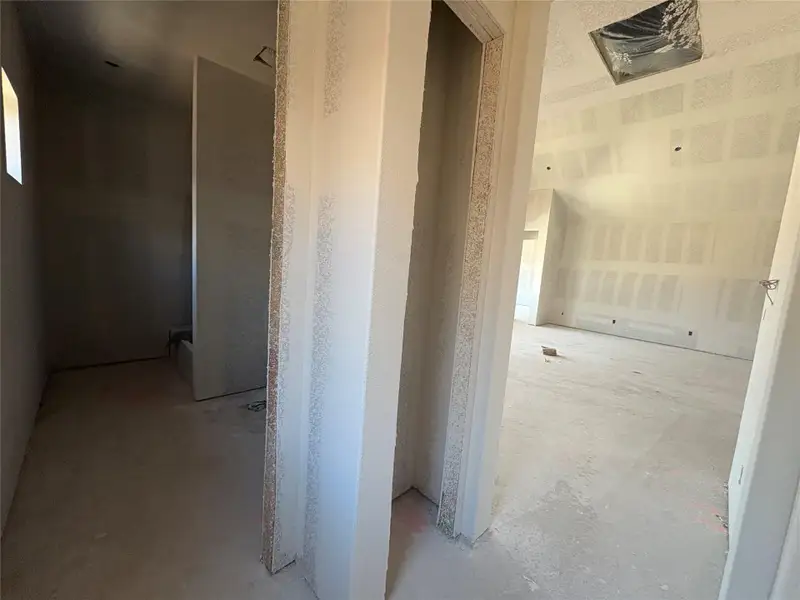 Hallway featuring unfinished concrete flooring Hallway featuring unfinished concrete flooring