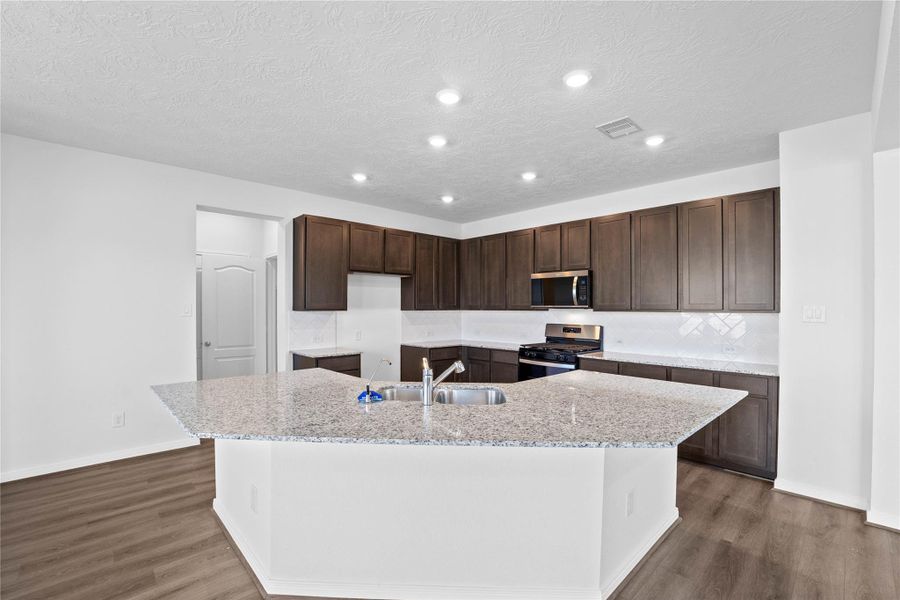This spacious kitchen has it all—ample storage, generous counter space, and a layout that truly makes it the heart of the home.