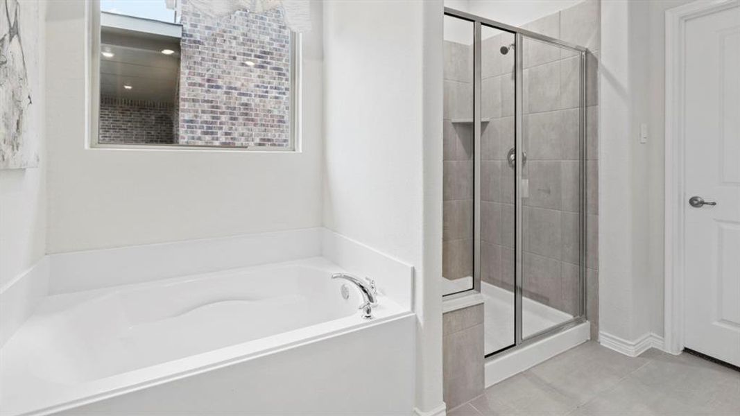 Bathroom featuring a garden tub and a stall shower